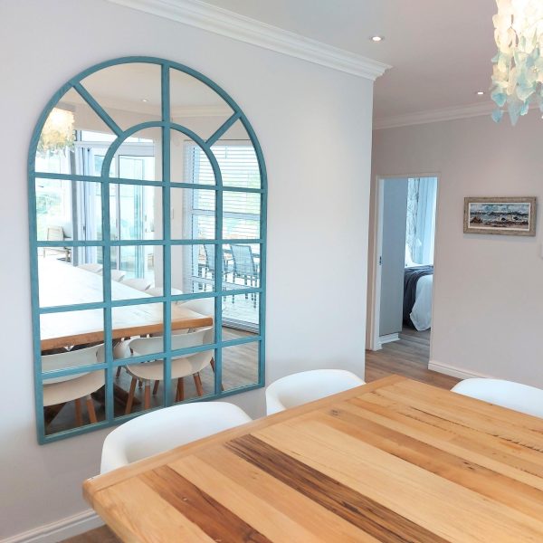 Lifestyle image of the Arch Mirror, showcasing its placement in a dining room